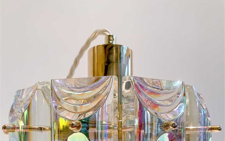 Iridescent prism-cut crystal pendant with Art Deco scallop pattern, brass spine and cream twisted cord catching rainbow light.